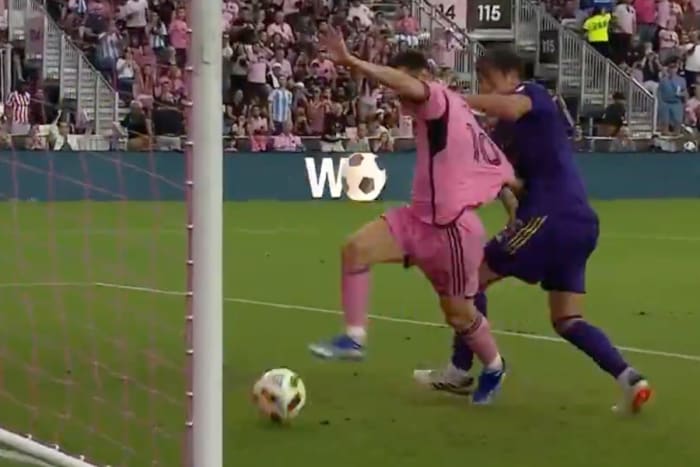 Rodrigo Schlegel pictured (right) pulling the jersey of Lionel Messi in an unsuccessful effort to stop the Inter Miami captain from scoring against Orlando City in an MLS game in March 2024